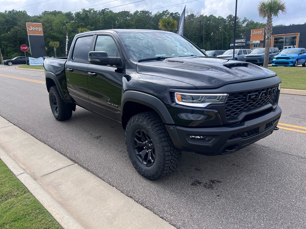 2026 RAM 1500 RAM 1500 RHO CREW CAB 4X4 5'7' BOX in Diamond Black Crystal Pearl-Coat Exterior Paint — front three-quarter view